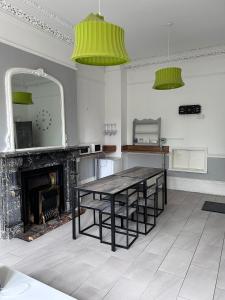 a dining room with a table and a fireplace at Triple room Private Bath Near LFC Free Street Parking No Breakfast in Liverpool
