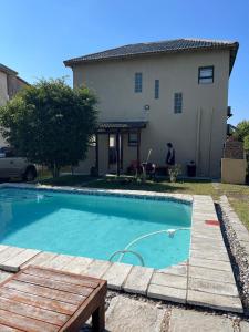 a swimming pool in front of a house at Casa Baleia Azul 8A Ponta Mamoli in Ponta Mamoli