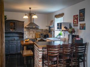 a kitchen with a table and some chairs in it at Tranquil Stay in Ardennes in Doische
