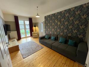 a living room with a couch with blue pillows at Apartment B34 in Bielefeld