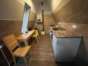 a small kitchen with wooden tables and a sink at Apartment B34 in Bielefeld +17 photos