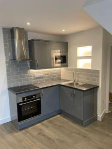 a kitchen with a sink and a stove at Bay view apartment in Penzance