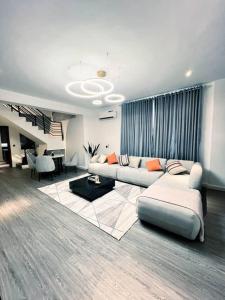 a living room with a couch and a table at TheHubCentral in Lekki
