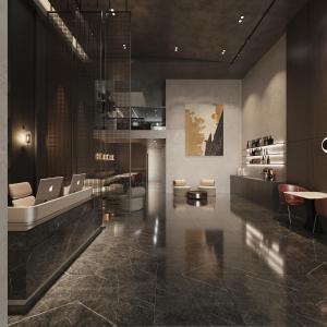 eine Lobby mit Stühlen und einem Tisch in einem Gebäude in der Unterkunft PureJoy Hotel Saigon in Ho-Chi-Minh-Stadt