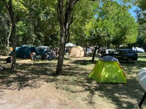 a group of tents in a field with trees at Emplacement tente, caravane 120 m2, Camping Beaussement in Chauzon +4 photos