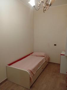 a small white room with a bed in it at Varacalli home in Siderno Marina