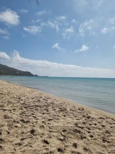 a sandy beach with a view of the ocean at Balcony of Carthage in Bin Rhilouf