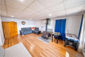 a living room with a couch and a table at SPA and Lake - Chalet le Relaxarium in Sainte-Germaine-du-Lac-Etchemin