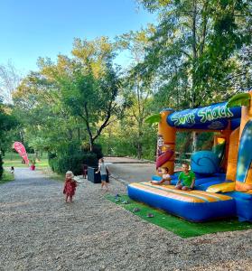 a group of children playing on a playground at Camping Beaussement Samouraï in Chauzon