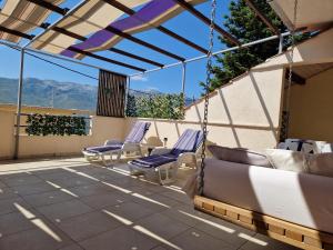 a patio with swing chairs on a roof at VILLAGE apartment in Zagvozd