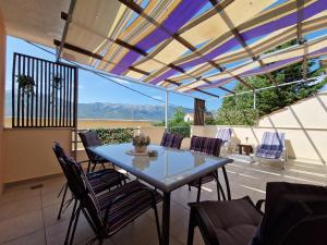 a table and chairs on a patio with a view at VILLAGE apartment in Zagvozd