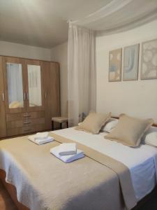 a bedroom with two beds with towels on them at VILLAGE apartment in Zagvozd