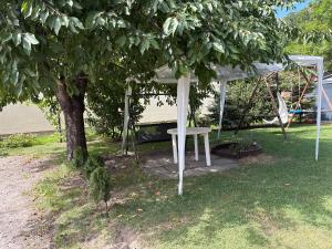 a white tent and a table under a tree at Apartament pod Książem in Świebodzice