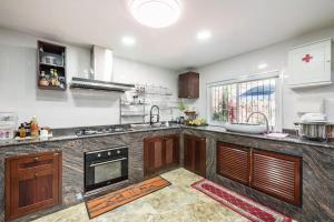 a kitchen with a sink and a stove top oven at Baan Alisa 12 in Nonthaburi