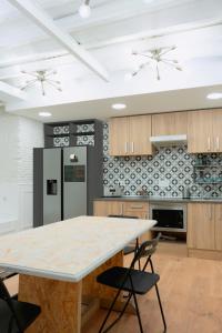 a kitchen with a large wooden table and chairs at Modular Dreams in Madrid