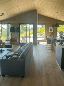 a living room with a couch and a table at Cabin With Panoramic Views At Skrim in Omholt