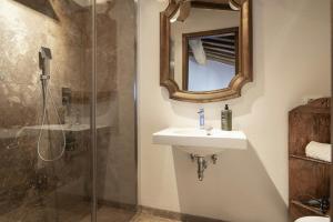 a bathroom with a sink and a shower at Historic Apartment With Tuscan Hills View in Villa del Monte +13 photos