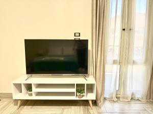a flat screen tv sitting on a white entertainment center at Rose Room in Cairo