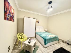 a small bedroom with a bed and a mirror at Rose Room in Cairo