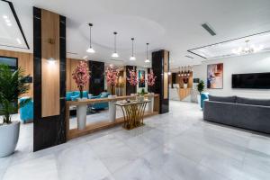 a lobby with a couch and a table at Renium Hotel Jazan in Jazan