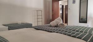 a bedroom with a bed and a mirror at Boa Fé Home Elvas in Elvas