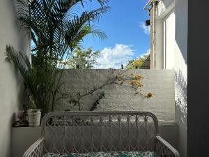 a metal bench sitting in front of a wall at LA Mili A Luxury Homestay in North Lakhimpur