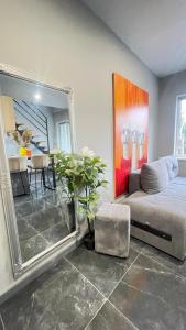 a bedroom with a bed and a large mirror at Family apartments N5 in Chernivtsi