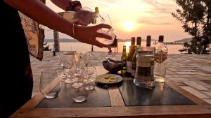 a table with wine glasses and bottles of wine at Umutuzo Lodge Kivu Lake in Buhoro