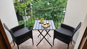 a table and two chairs on a balcony at Boutique wine rezidence in Hnanice