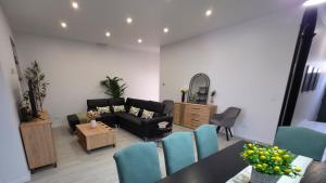 a living room with a couch and a table and chairs at City Garden Villa , Ponta Delgada in Ponta Delgada