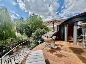 a wooden deck with a table and an umbrella at Domizil am Festspielhaus in Bayreuth