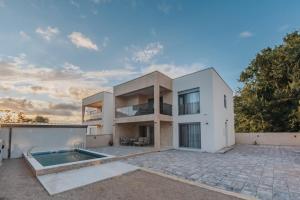 a large white house with a swimming pool at Villa Anida in Ulcinj