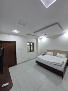 a bedroom with a bed and a flat screen tv at HK Resort  +10 photos