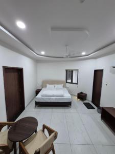 a bedroom with a bed and a table and chairs at HK Resort 
