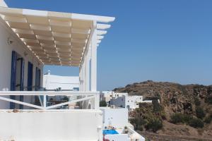 a view of a white building with a roof at Studios Betty in Plaka Milou