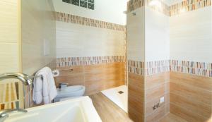 a bathroom with a toilet and a sink at Le rose di Mimmo Casa vacanze in Barcellona-Pozzo di Gotto