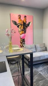 a painting of a giraffe with a pink tongue at Двох рівнях апартамент для 3 осіб N1 in Chernivtsi +10 photos