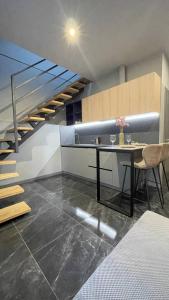 a kitchen with a table and a staircase in a room at Двох рівнях апартамент для 3 осіб N1 in Chernivtsi