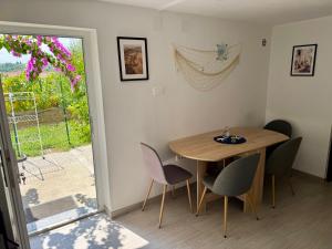 a dining room with a table and chairs and a window at Moon Bay apartment - Free large parking in Portorož