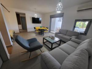 a living room with a couch and a table at Vila Pejic Xenia beach in Paliouri