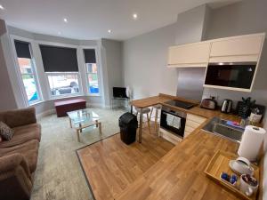 a living room with a couch and a table at 8 Aspland Road in Norwich