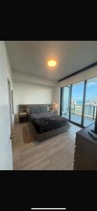 a bedroom with a large bed and a large window at New 1Bed 1 bath Ocean view in Miami Beach