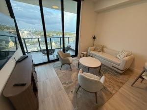 a living room with a couch and a table and chairs at New 1Bed 1 bath Ocean view in Miami Beach