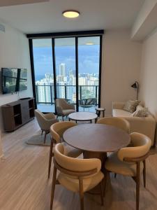 a living room with tables and chairs and a couch at New 1Bed 1 bath Ocean view in Miami Beach