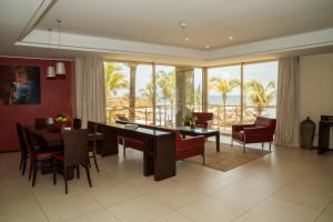 a dining room and living room with a dining table at Terrou-Bi in Dakar