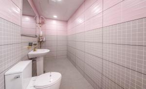 a pink bathroom with a toilet and a sink at 목포 머니스테이 호텔청담 in Mokpo +37 photos