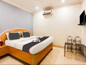 Un dormitorio con una cama y un televisor. en Hotel Stay Land Inn Versova, en Bombay