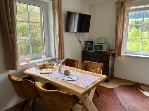 a dining room with a wooden table and chairs at Ferienhaus energieautark in Mariahof in Mariahof