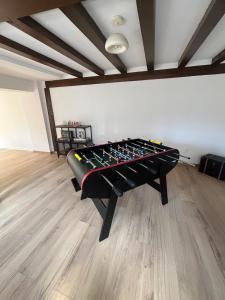 a room with a pool table in the middle of it at Maison cosy - salle de jeux, cinéma et jacuzzi in Ittenheim