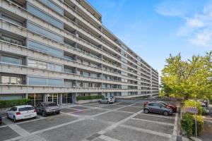 a parking lot in front of a building at Taverney - Spacieux appartement lumineux aux portes de Genève in Geneva
